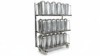 Metal storage rack with various containers on wheels in a warehouse setting