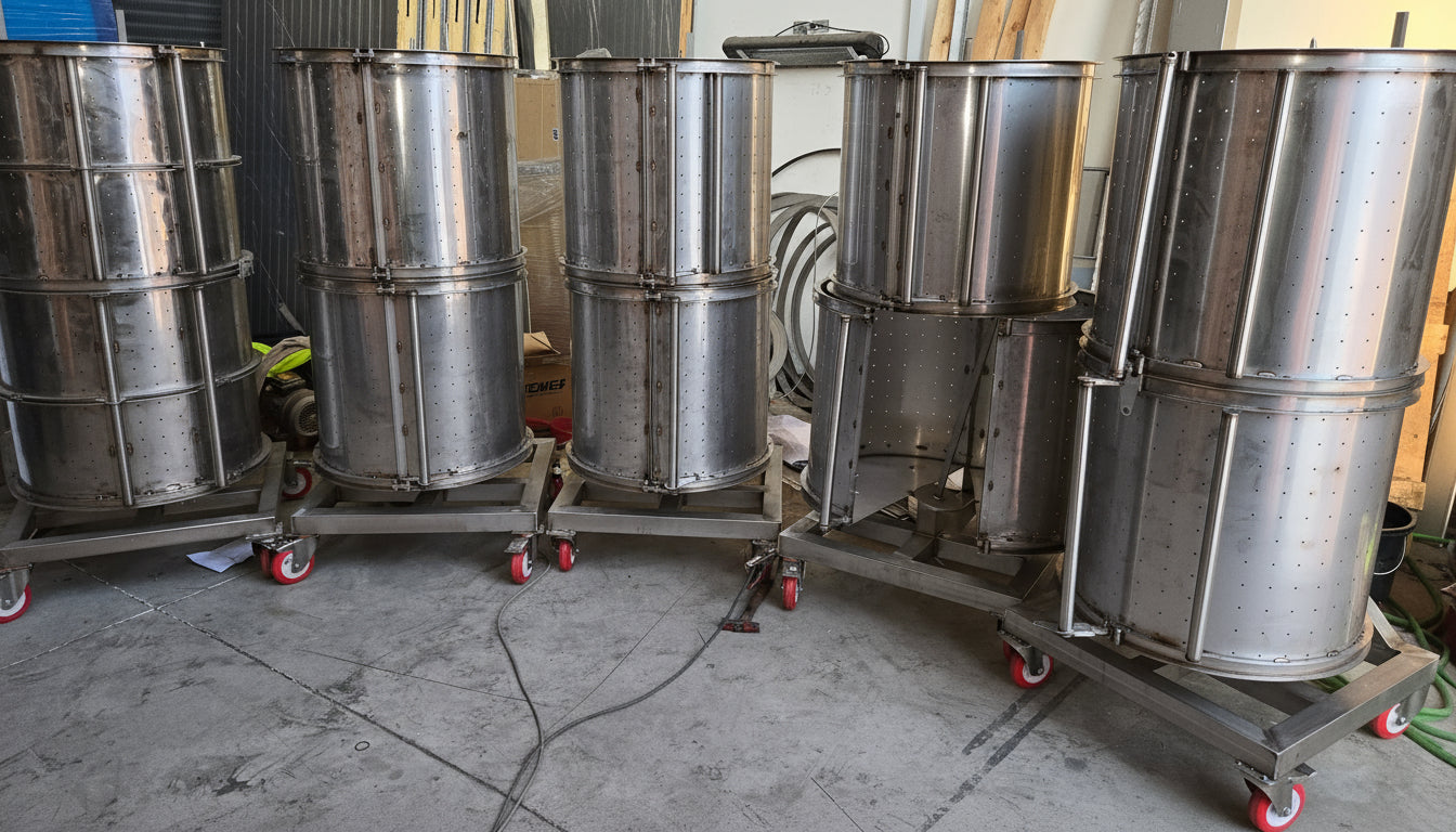 Set of metal drums on wheels in a workshop setting