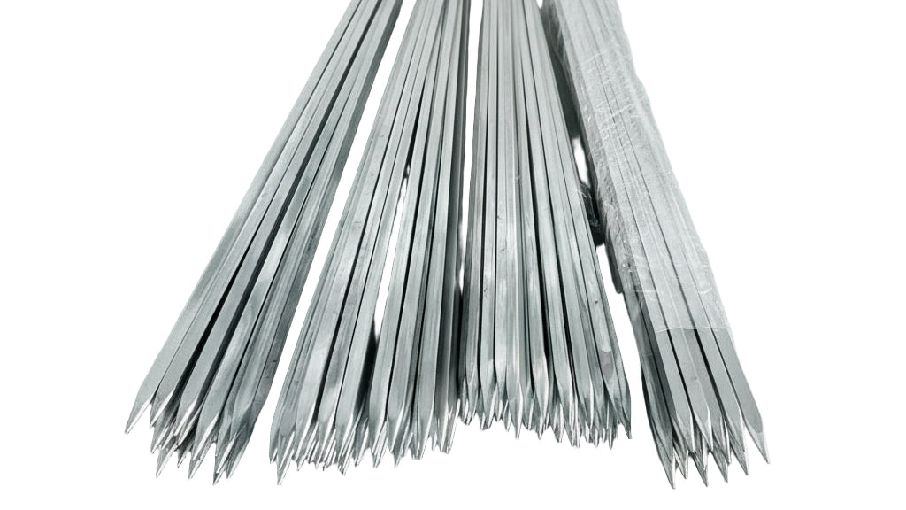 Metal rods stacked together on a textured surface