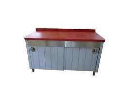 Stainless steel counter with a red countertop on a white background