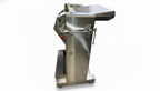 Stainless steel meat grinder on a tiled floor